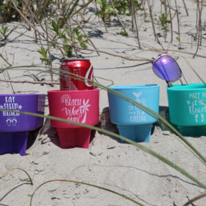 A group of cups sitting on top of the sand.