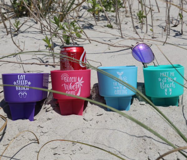 A group of cups sitting on top of the sand.